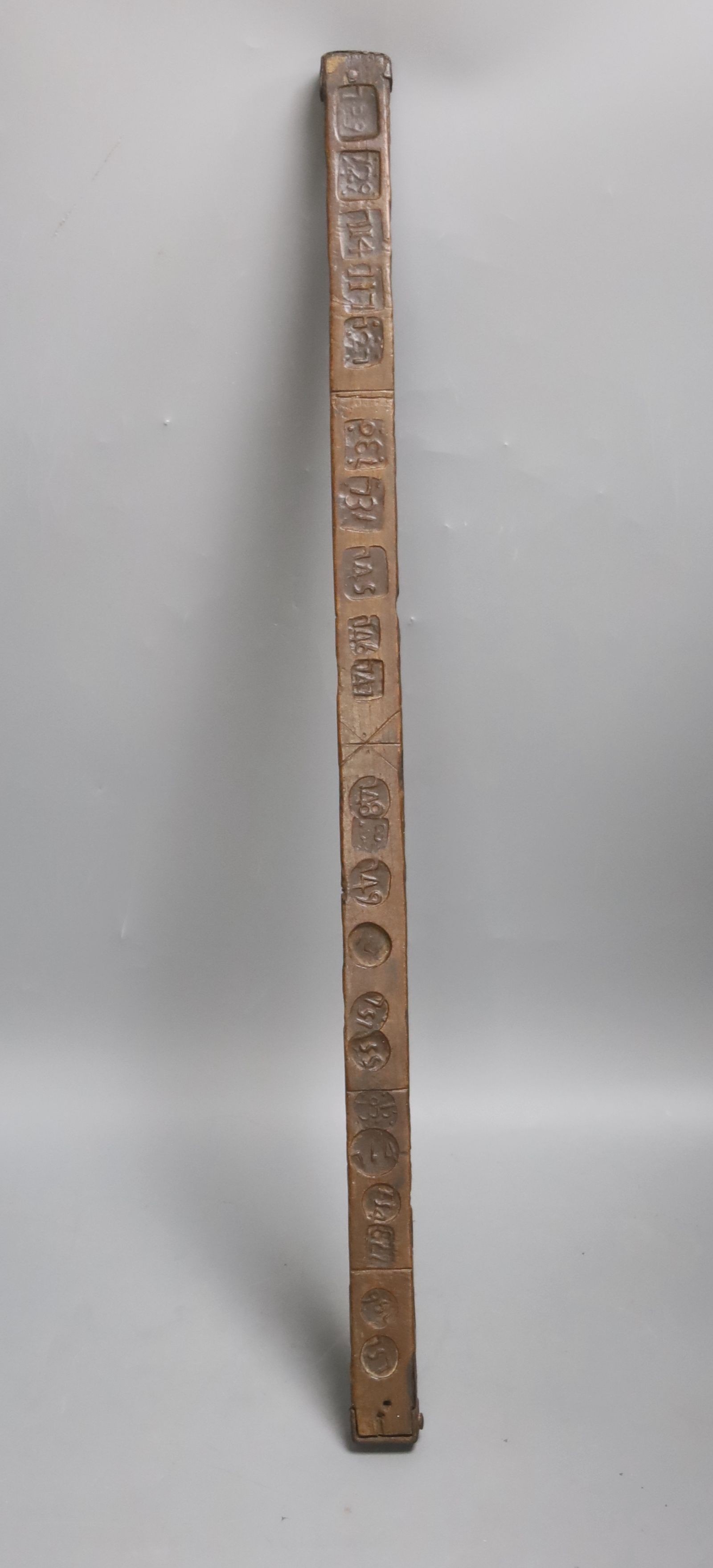 An unusual 18th/19th century rule/gauge or tally stick with impressed numerals, 26cm long